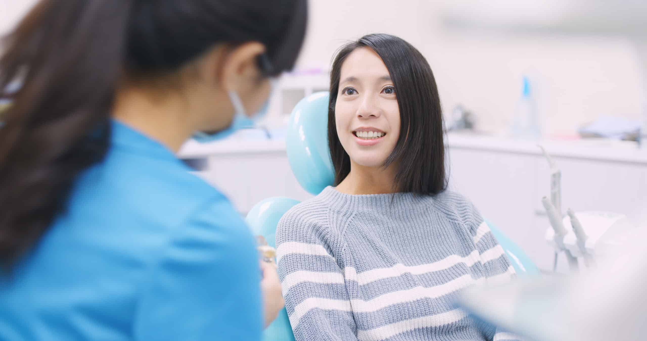 Woman,Talk,To,Dentist,In,Dental,Clinic