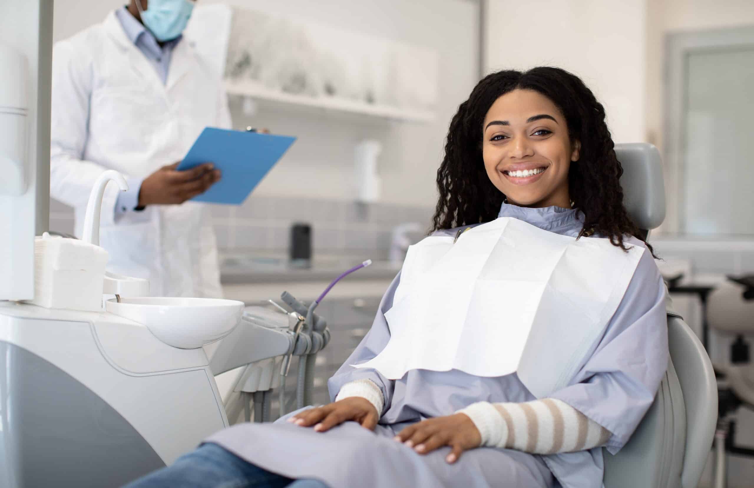 Happy,Young,African,American,Woman,Sitting,In,Chair,During,Appointment